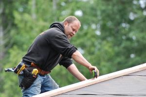 a Castro Valley handyman works on a roof repair